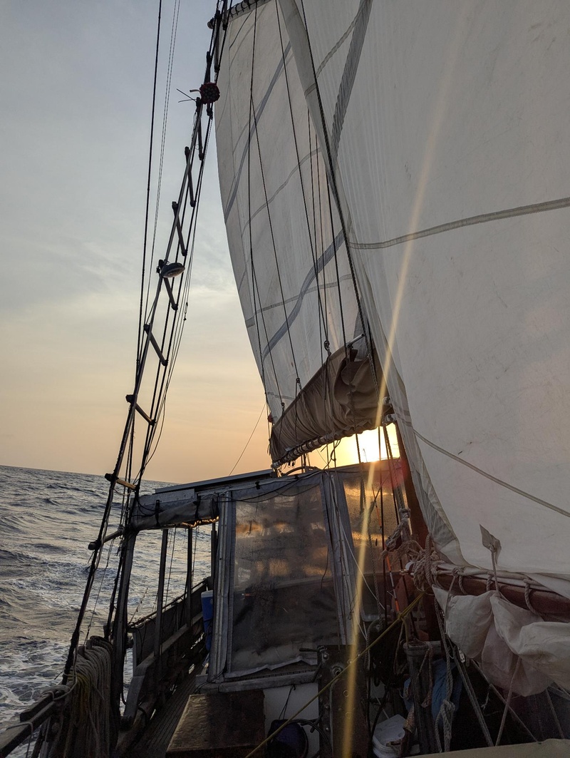 Sonnenuntergang im Rücken auf offener See.
